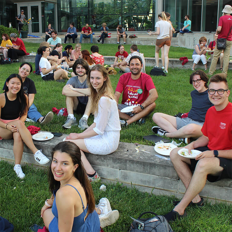 Students enjoying food on the lawn at the Global and International Studies Building.