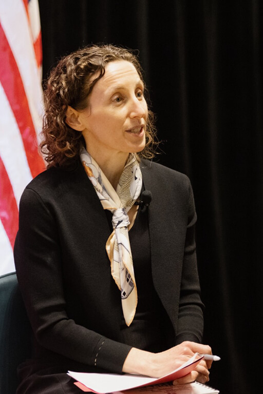 Sarah Bauerle Danzman speaking on a stage panel.